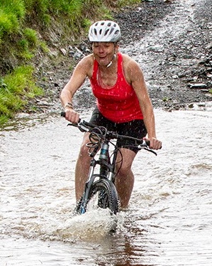 Cyclist splashing through ford